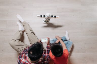 top view shot of people controlling the robot using a cellphone